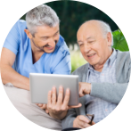 Male nurse and senior men smiling while using tablet computer