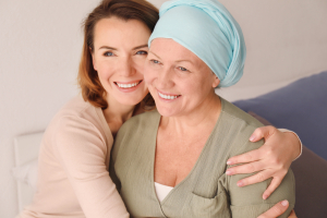 A caregiver and a patient smiling